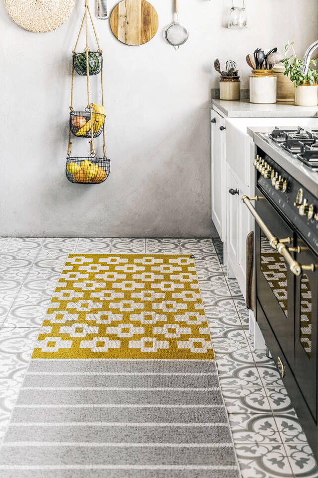 Black / grey runner plastic -  Carpet in a kitchen.