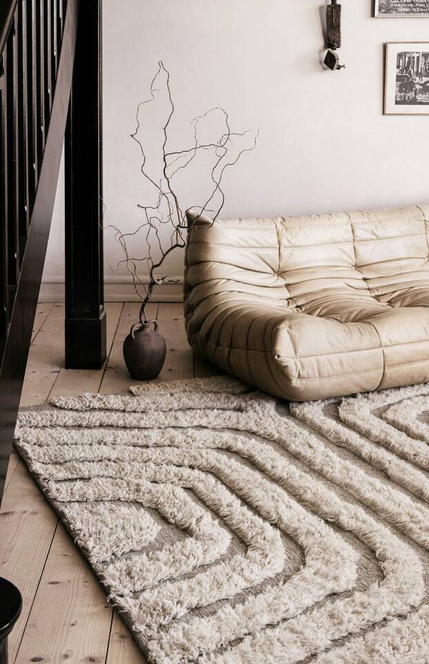 White rectangular high & low handknotted wool -  Carpet in a living room.