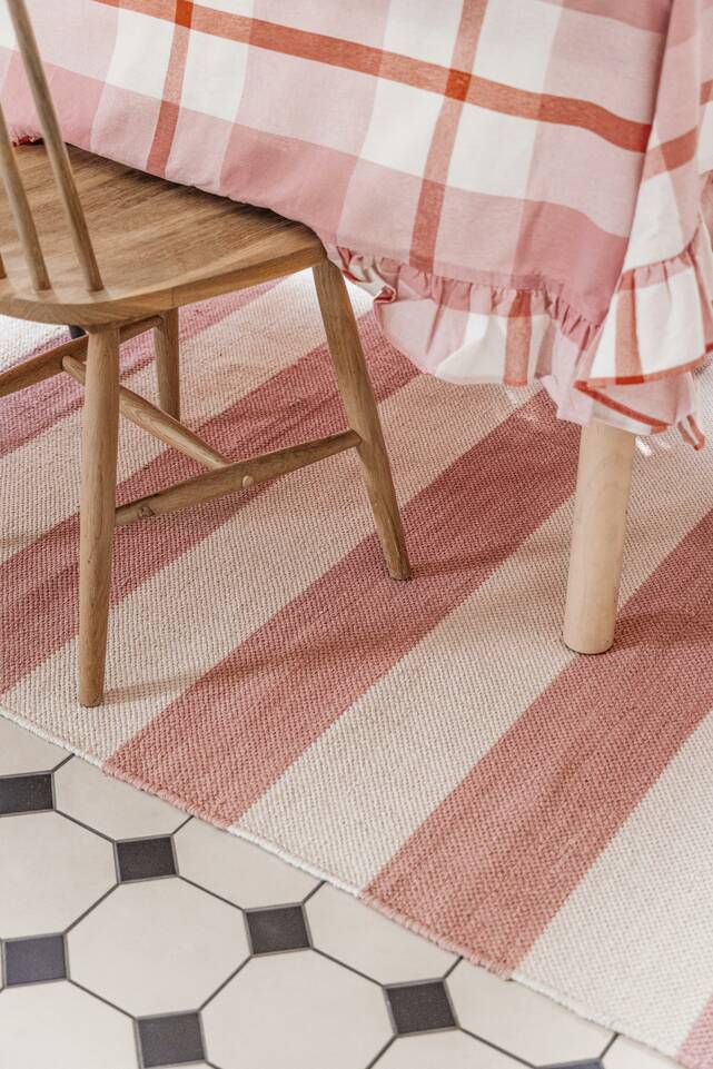 Pink  cotton dhurrie -  Carpet in a dining area.